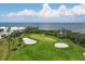 Golf course with sand traps and green next to the water at 3060 Grand Bay Blvd # 175, Longboat Key, FL 34228