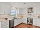 Elegant kitchen featuring stainless steel appliances, white cabinetry, and marble countertops at 3060 Grand Bay Blvd # 175, Longboat Key, FL 34228
