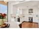 Modern white kitchen with marble backsplash and hardwood floors at 3060 Grand Bay Blvd # 175, Longboat Key, FL 34228