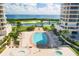 Community pool and hot tub with lush landscaping and water views at 3060 Grand Bay Blvd # 175, Longboat Key, FL 34228