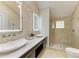 Elegant bathroom with dual sinks, marble countertops, and a large walk-in shower at 3514 62Nd E St, Bradenton, FL 34208