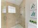 Large walk-in shower with glass enclosure and pebble tile floor at 3514 62Nd E St, Bradenton, FL 34208