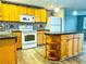Bright kitchen featuring wood cabinets, an island, and updated appliances at 360 Flamingo Rd, Venice, FL 34293