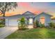 Cute one-story home with a landscaped lawn, attached garage, and a walkway to the front door at 3712 62Nd E Ave, Bradenton, FL 34203