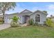 One-story home with a two-car garage, mature landscaping, and a charming front entrance at 3712 62Nd E Ave, Bradenton, FL 34203