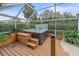 Relax in this screened-in hot tub with wooden deck at 3712 62Nd E Ave, Bradenton, FL 34203