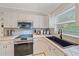 Kitchen features a black farm sink and updated appliances at 3712 62Nd E Ave, Bradenton, FL 34203