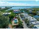 Aerial view showing community pool, tennis court, and building at 3805 E Bay Dr # 302, Holmes Beach, FL 34217