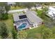 Aerial view showing home with pool, solar panels, and lush landscaping at 3826 E 155Th E Ave, Parrish, FL 34219
