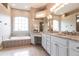 Large Primary bathroom with granite vanity and soaking tub at 3826 E 155Th E Ave, Parrish, FL 34219