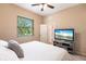 Bedroom with king-size bed, TV, and access to bathroom at 3826 E 155Th E Ave, Parrish, FL 34219