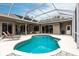 Relaxing kidney-shaped pool with a screened enclosure and comfortable lounge chairs at 3826 E 155Th E Ave, Parrish, FL 34219