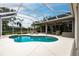 Inviting pool area with screened enclosure, lounge chairs, and a spacious deck at 3826 E 155Th E Ave, Parrish, FL 34219