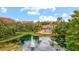 Community pool and pond with fountain, surrounded by lush greenery at 4110 Central Sarasota Pkwy # 136, Sarasota, FL 34238