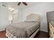 Bright bedroom with double bed, wooden dresser, and ceiling fan at 4110 Central Sarasota Pkwy # 136, Sarasota, FL 34238