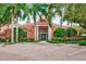 Attractive community entrance with lush landscaping and brick paved courtyard at 4110 Central Sarasota Pkwy # 136, Sarasota, FL 34238
