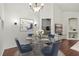 Bright dining area with glass table and four blue chairs at 4110 Central Sarasota Pkwy # 136, Sarasota, FL 34238