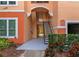 Condo building entrance with stairs and landscaping at 4110 Central Sarasota Pkwy # 136, Sarasota, FL 34238