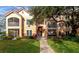 Two-story condo building with balconies and lush landscaping at 4110 Central Sarasota Pkwy # 136, Sarasota, FL 34238