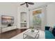 Living room with hardwood floors, balcony access, and teal sofa at 4110 Central Sarasota Pkwy # 136, Sarasota, FL 34238