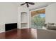 Living room with hardwood floors, built-in shelving and balcony access at 4110 Central Sarasota Pkwy # 136, Sarasota, FL 34238