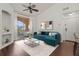 Spacious living room, teal sectional sofa, wood floors, and balcony access at 4110 Central Sarasota Pkwy # 136, Sarasota, FL 34238