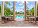 Relaxing pool view from covered patio with seating area at 4110 Central Sarasota Pkwy # 136, Sarasota, FL 34238