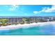 Aerial of beachfront condo building showcasing ocean and city views at 415 L Ambiance Dr # A701, Longboat Key, FL 34228