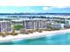 Aerial view of beachfront condo building with pool and city skyline at 415 L Ambiance Dr # A701, Longboat Key, FL 34228