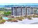 Luxury beachfront condo building with pool and lush landscaping at 415 L Ambiance Dr # A701, Longboat Key, FL 34228