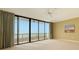 Bedroom with ocean view and sliding glass doors at 415 L Ambiance Dr # A701, Longboat Key, FL 34228