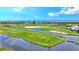 Aerial view of a lush golf course with water features at 415 L Ambiance Dr # A701, Longboat Key, FL 34228