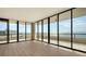 Empty living room with hardwood floors and ocean view at 415 L Ambiance Dr # A701, Longboat Key, FL 34228