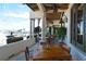 Outdoor patio with water views and wooden tables at 415 L Ambiance Dr # A701, Longboat Key, FL 34228
