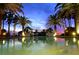 Tranquil pool at sunset with palm trees at 415 L Ambiance Dr # A701, Longboat Key, FL 34228