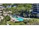 Resort-style pool surrounded by lush landscaping at 415 L Ambiance Dr # A701, Longboat Key, FL 34228