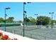 Well-lit tennis courts with seating area at 415 L Ambiance Dr # A701, Longboat Key, FL 34228