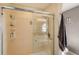 Bathroom with shower stall, tiled walls, and built-in shelves at 4230 Castlebridge Ln # 1821, Sarasota, FL 34238