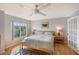 Bright bedroom with king bed, ceiling fan, and hardwood floors at 4230 Castlebridge Ln # 1821, Sarasota, FL 34238