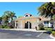 Community clubhouse with columns and palm trees at 4230 Castlebridge Ln # 1821, Sarasota, FL 34238