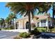 Community clubhouse with columns and lush landscaping at 4230 Castlebridge Ln # 1821, Sarasota, FL 34238