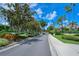 Gated community entrance with lush landscaping at 4230 Castlebridge Ln # 1821, Sarasota, FL 34238