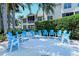 Relaxing community patio with blue chairs and fire pit at 4230 Castlebridge Ln # 1821, Sarasota, FL 34238