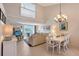 Bright dining area with chandelier and view into living room at 4230 Castlebridge Ln # 1821, Sarasota, FL 34238