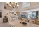 Open concept dining room with chandelier and view of living room at 4230 Castlebridge Ln # 1821, Sarasota, FL 34238