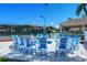 Fire pit area with blue chairs near tennis courts at 4230 Castlebridge Ln # 1821, Sarasota, FL 34238