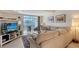 Relaxing living room features comfy sectional sofa and access to balcony at 4230 Castlebridge Ln # 1821, Sarasota, FL 34238