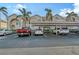 Exterior view of condo building with covered parking and landscaping at 4230 Castlebridge Ln # 1821, Sarasota, FL 34238