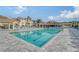 Relaxing resort-style pool with numerous lounge chairs at 4230 Castlebridge Ln # 1821, Sarasota, FL 34238