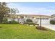 White single-story house with a two-car garage and lush landscaping at 4477 Opal Ct, Sarasota, FL 34233